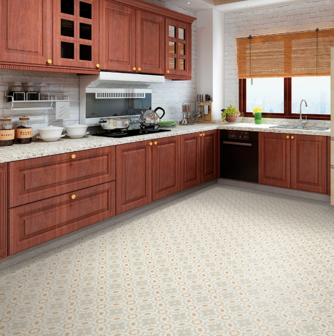 Patterned luxury vinyl tile floors draw the eye across a large kitchen with dark cabinets and marble countertops.